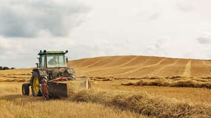 A tractor harvesting grain