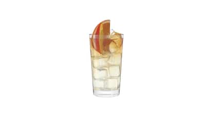 Absolut Peach Dream in a highball glass with ice cubes and peach slices on white background