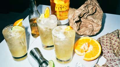 Three Absolut Mandrin Punch cocktails on a white table