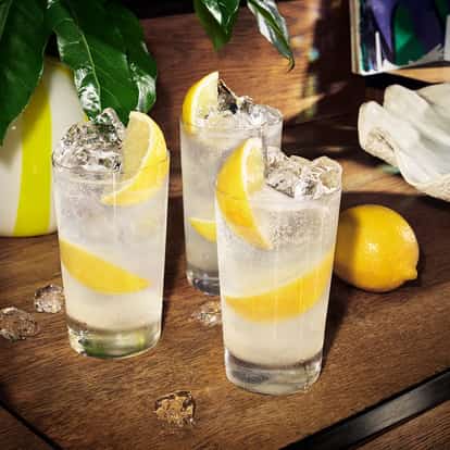 three Absolut Lemonade cocktail glasses presented on a table