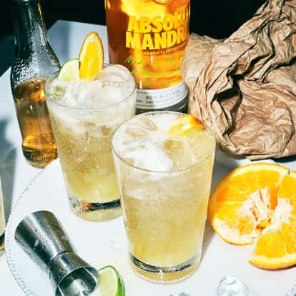 Three Absolut Mandrin Punch cocktails on a white table