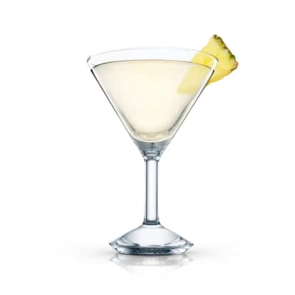 Absolut Peppar Pineapple Martini served in a martini glass with pineapple wedge on rim on white background
