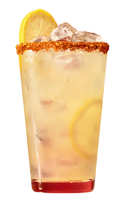 Close-up of a tall spicy lemonade cocktail with ice, a Cajun spice rim, lemon slices, and a chilled, translucent yellow drink