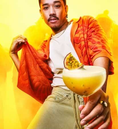A man  holds an Absolut Passionfruit Martini