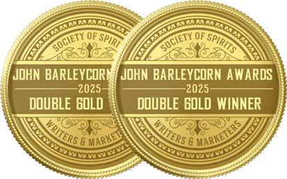 Two gold medals displaying “John Barleycorn Awards 2025 Double Gold Winner” from the Society of Spirits Writers & Marketers.